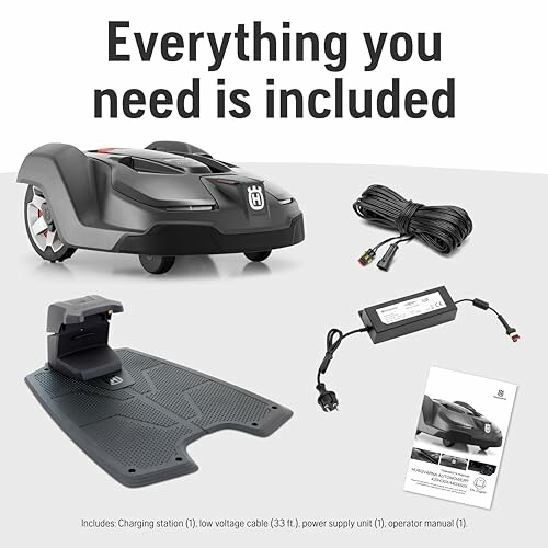 Robot lawn mower with charging station, cables, and manual.