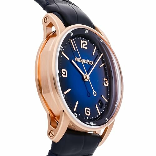 Audemars Piguet watch with blue dial and gold case.