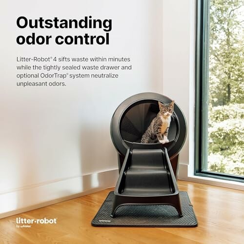 Cat sitting on an automatic litter box with text about outstanding odor control.