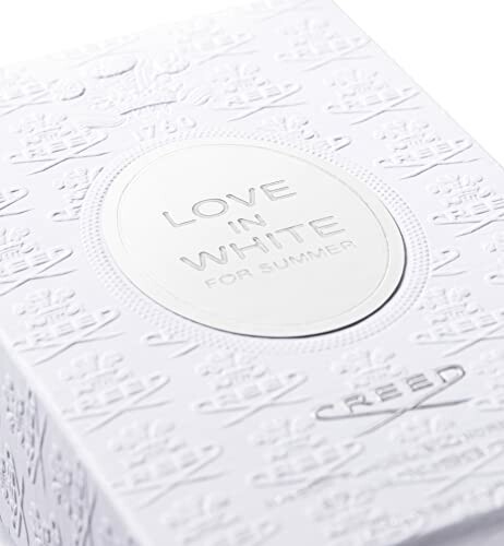 Close-up of Creed Love in White perfume box with embossed design.
