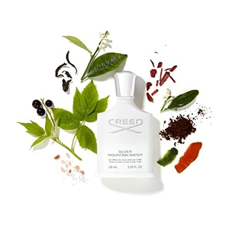 Creed Silver Mountain Water perfume bottle surrounded by natural ingredients.