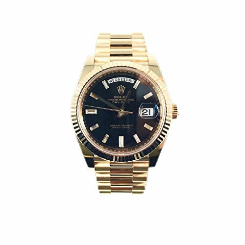 Gold wristwatch with black dial displaying date and day