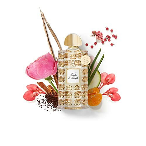 Perfume bottle surrounded by pink flowers and spices