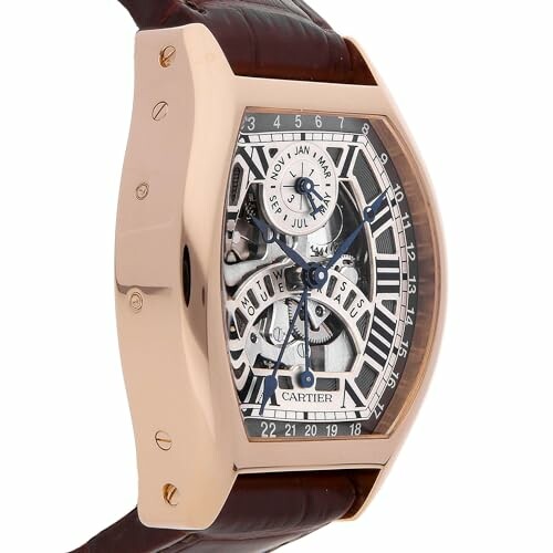 Rose gold skeleton watch with leather strap displaying months and date.