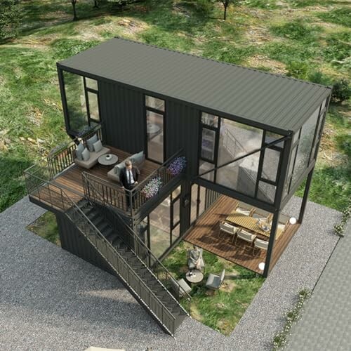 Aerial view of a modern two-story container home with outdoor seating and stairs.