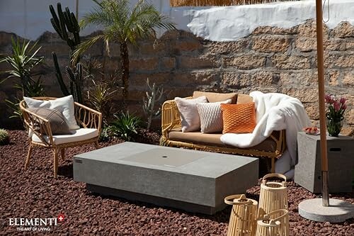Outdoor patio with wicker furniture and cushions.