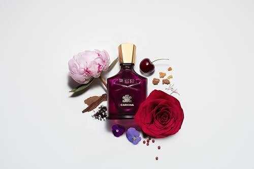 Perfume bottle surrounded by flowers and spices.