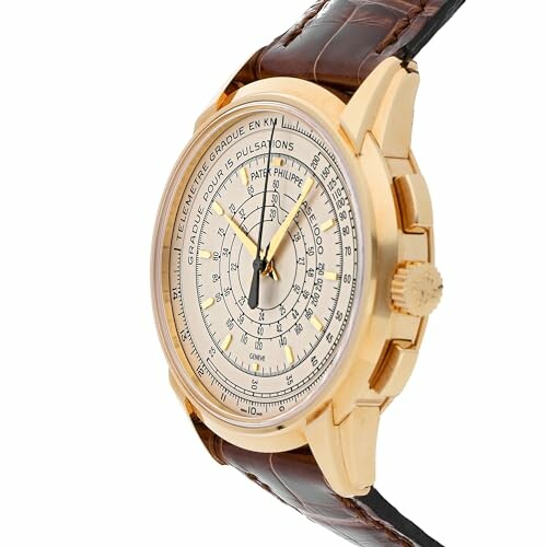 Vintage gold wristwatch with leather strap and intricate dial