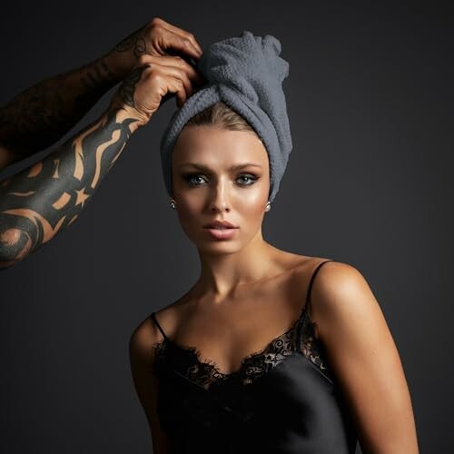 Woman with towel on head being adjusted